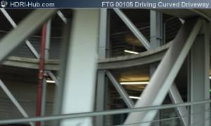 Driving Curved Driveway - View out of car while driving a curved driveway in a parking deck.